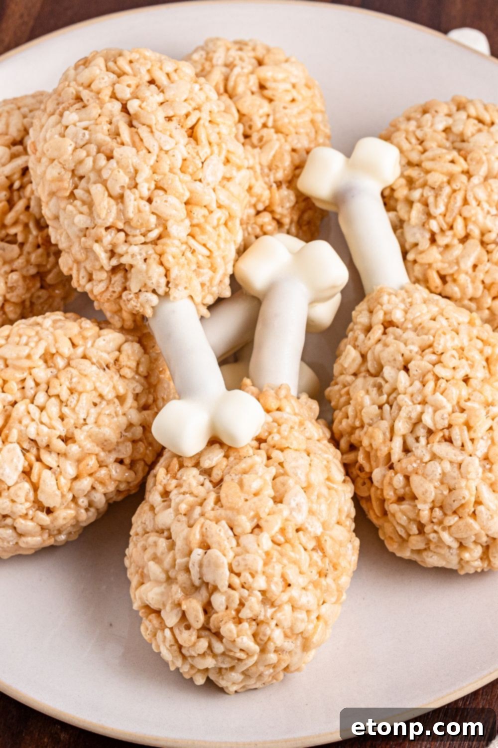 Rice Krispie Treat Turkey Legs stacked on a platter overlapping one another 