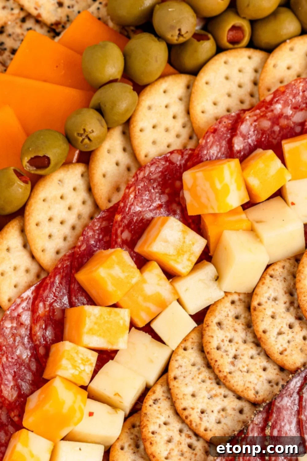 Turkish Mezze Spread 5 Neatly arranged rows of various cheeses, crackers, and cured meats laid out on a table, ready for assembly into a charcuterie board.