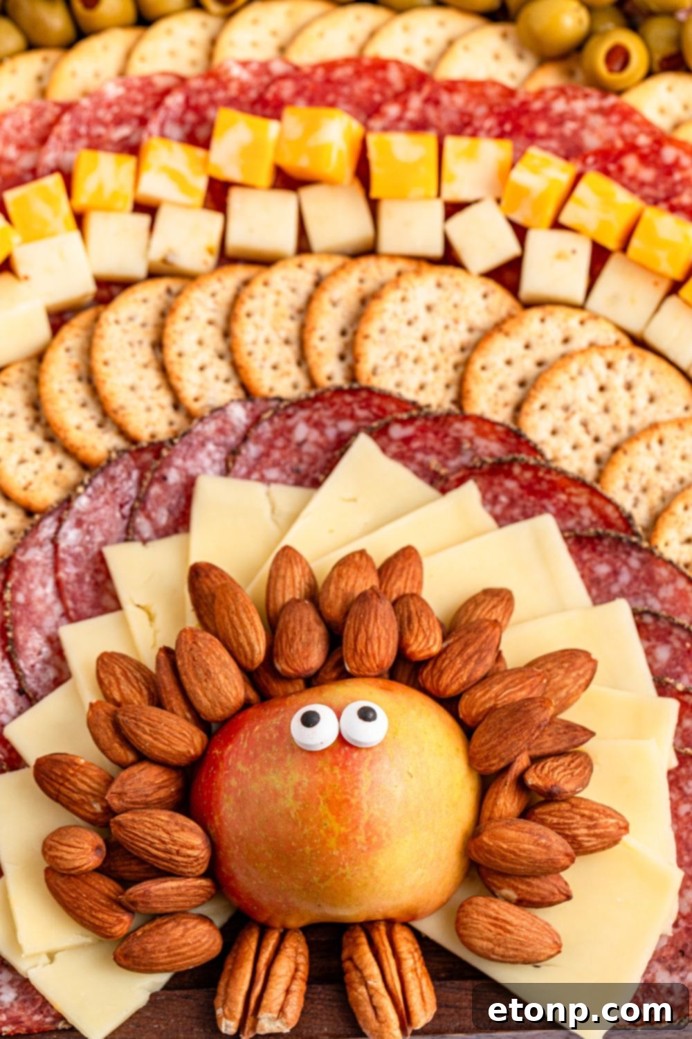 Turkish Mezze Spread 10 Close-up of the turkey's face on the snack board, highlighting the apple body with candy eyes applied.