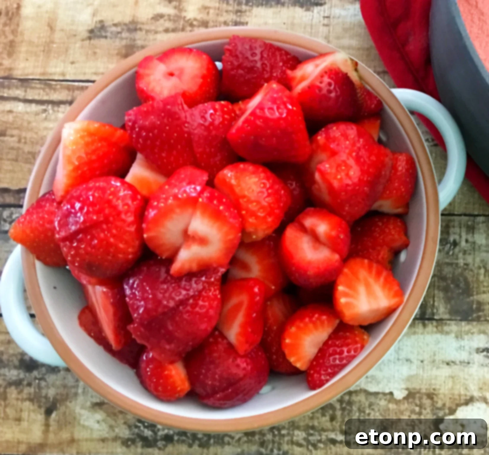 Glass jars filled with strawberry moonshine and fresh berries
