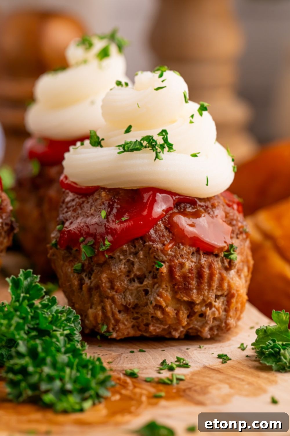 Meatloaf Cupcakes sitting on table with some parsley around it 