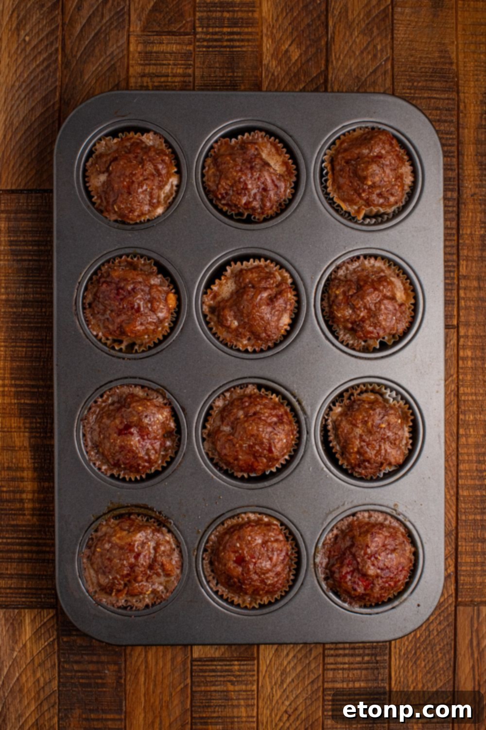 cooked meatloaf in a cupcake tray sitting on the table