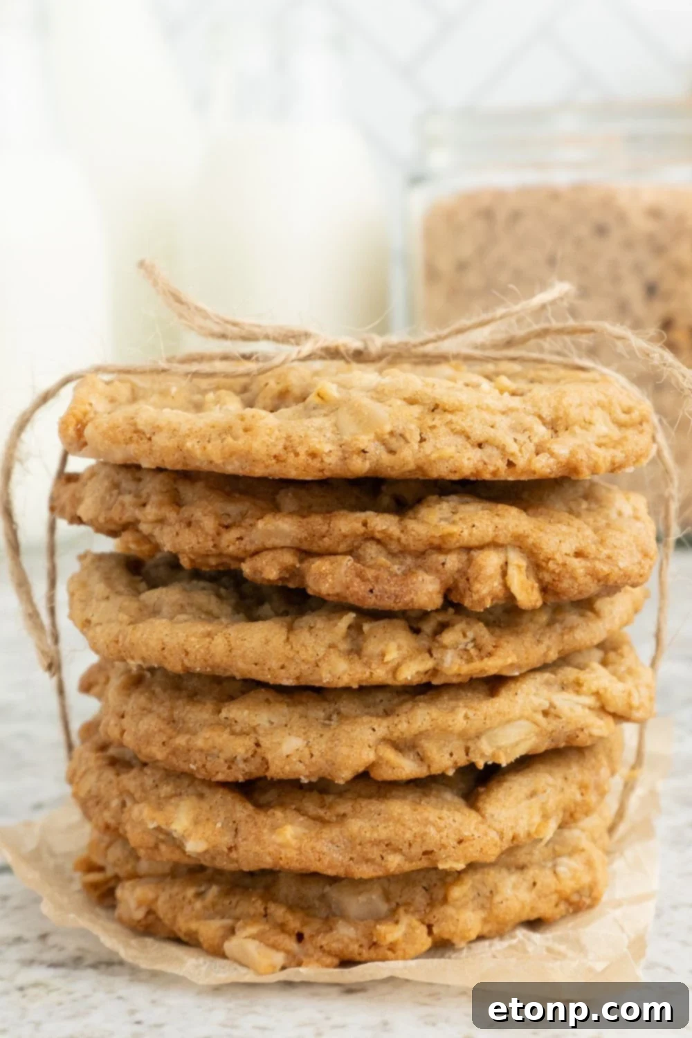 Chewy Toffee Oatmeal Cookies 11 A neatly stacked pile of Oatmeal Toffee Cookies, charmingly tied with a decorative ribbon, perfect for gifting.