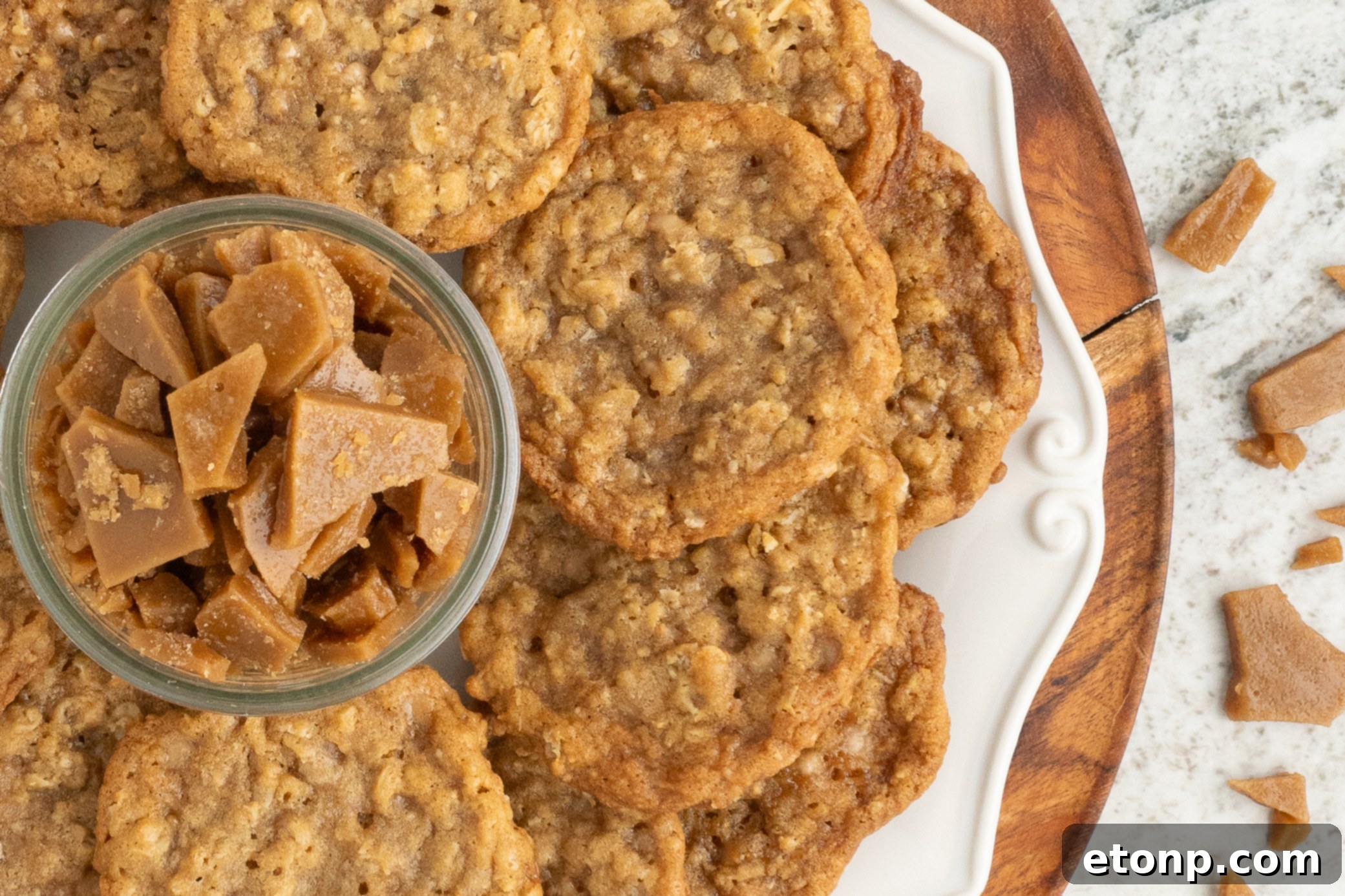 Chewy Toffee Oatmeal Cookies 18 A tray of freshly baked Oatmeal Toffee Cookies, beautifully arranged, with a small bowl of crunchy toffee bits in the center, symbolizing their key ingredient.