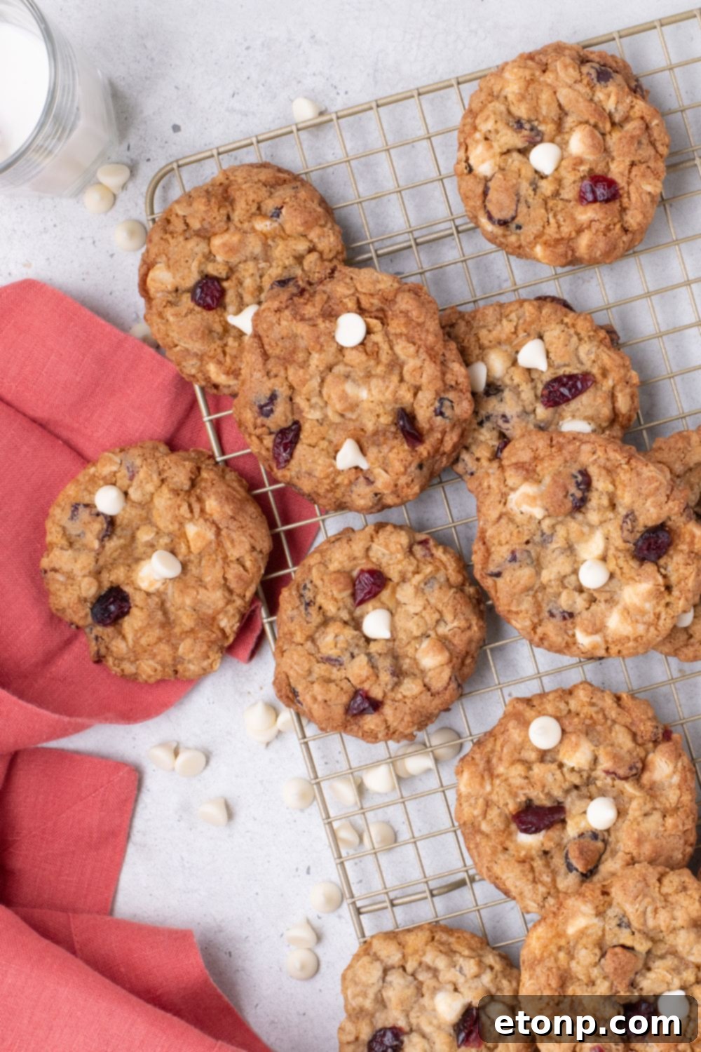 White Chocolate Cranberry Oatmeal Cookies on a cooling rack spread out around table 