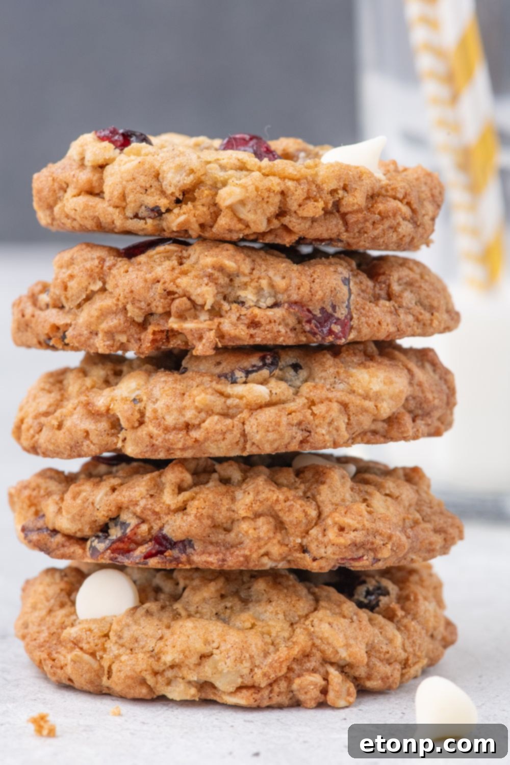 White Chocolate Cranberry Oatmeal Cookies stacked on table 