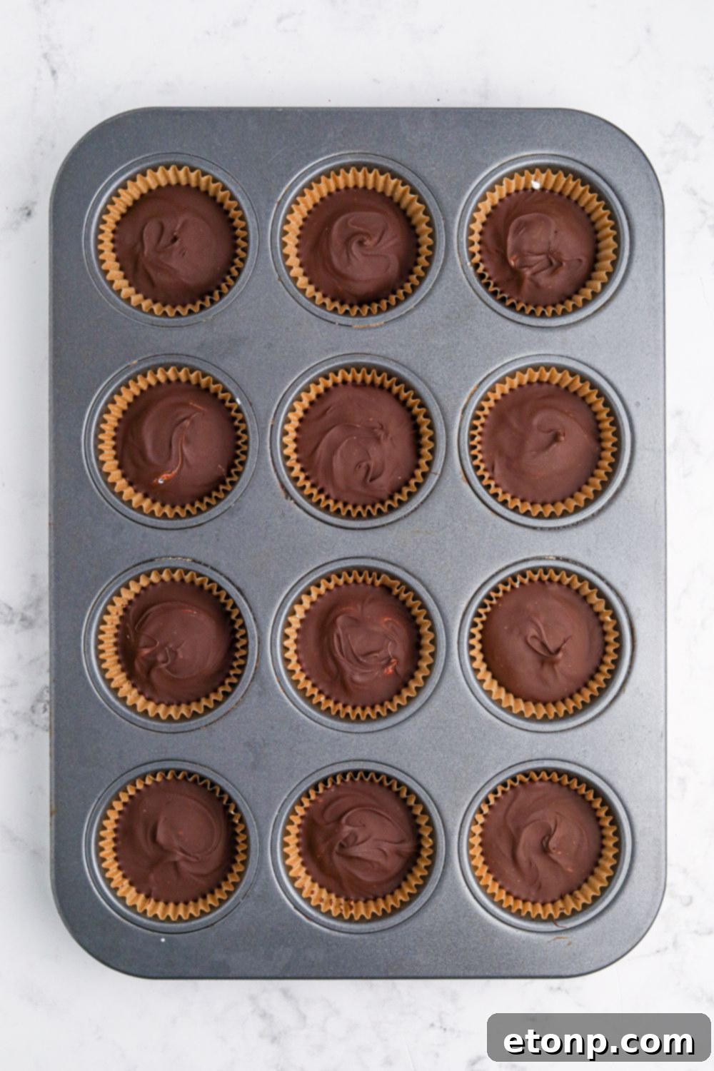 Peanut Butter Marshmallow Cups in  muffin tin on table 
