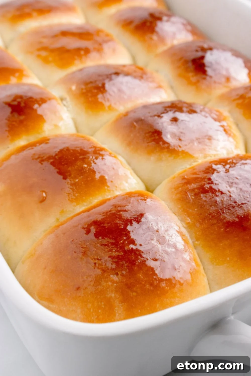 buttered Hawaiian rolls in a pan 