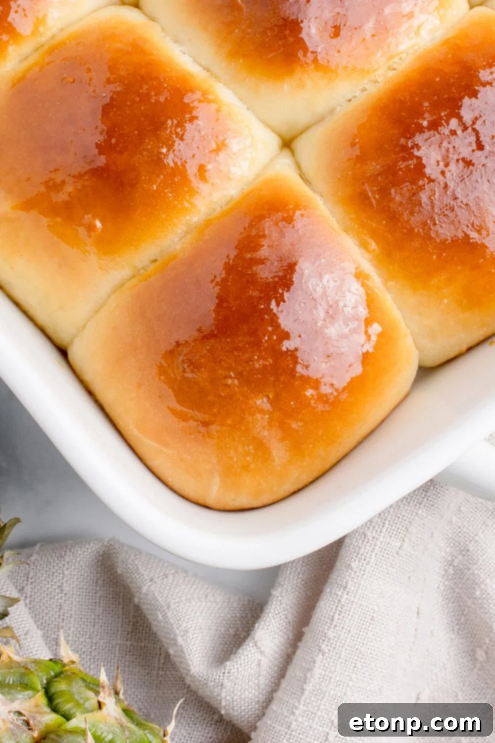 hawaiian sweet rolls in a pan that are buttered