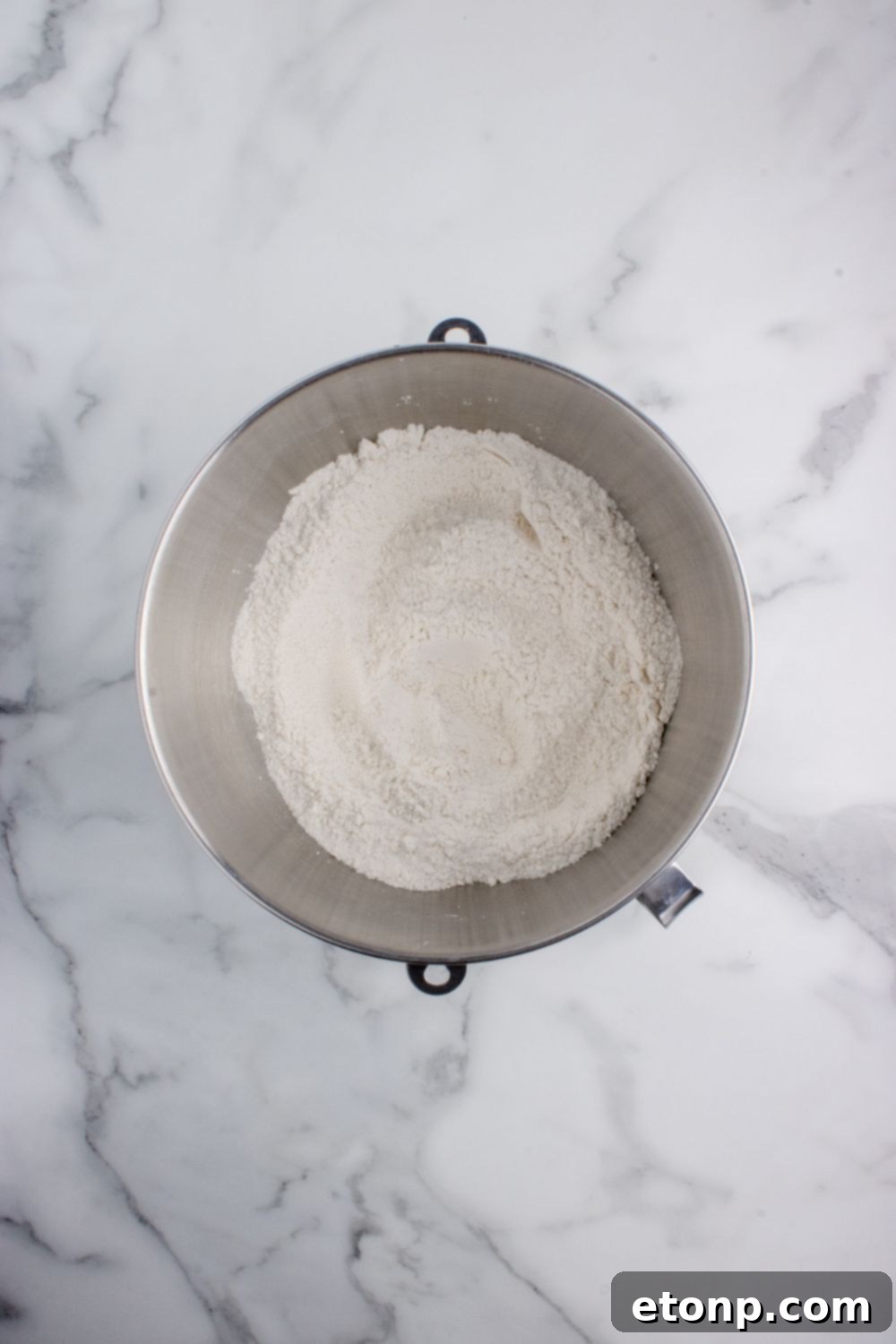 flour in a mixing bowl on table for making Hawaiian rolls