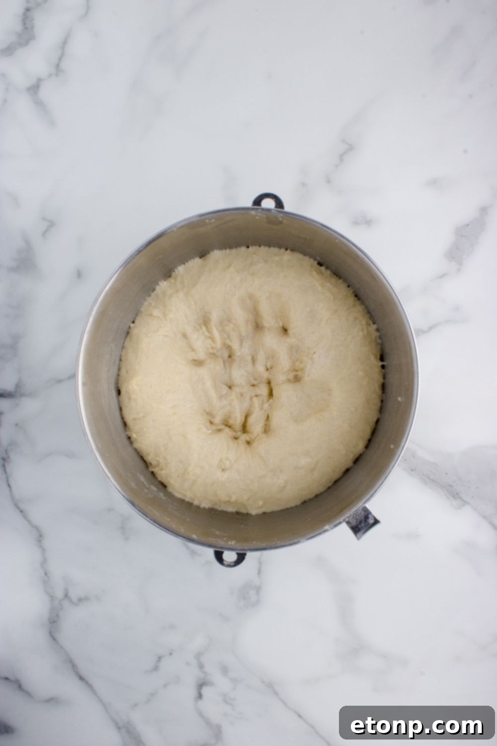 bread dough risen in a bowl on table for making Hawaiian rolls