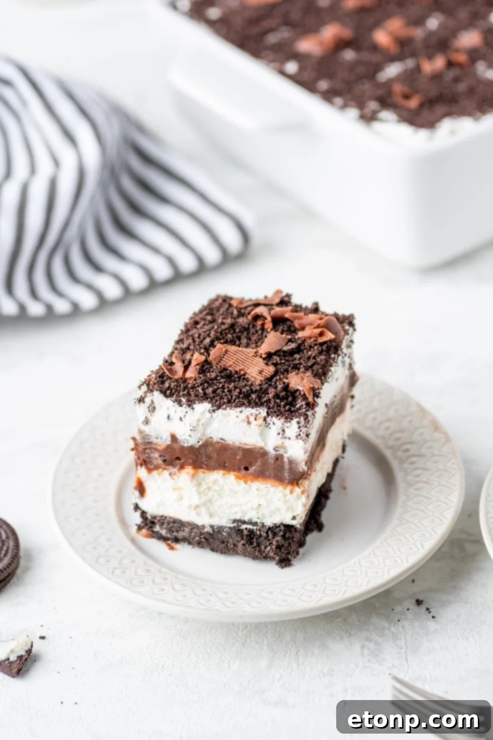 Decadent Chocolate Oreo Dream 13 slice of Chocolate Oreo Lush on a plate with a fork in front of plate on table