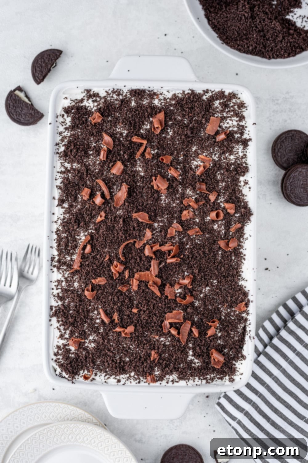 Decadent Chocolate Oreo Dream 4 Chocolate Oreo Lush in casserole pan sitting on counter with cookies around it