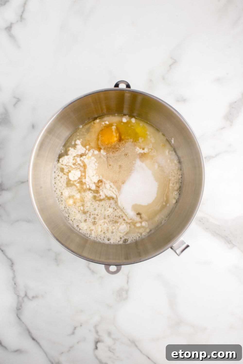 Mixing bowl with ingredients for pull apart rolls on a kitchen counter