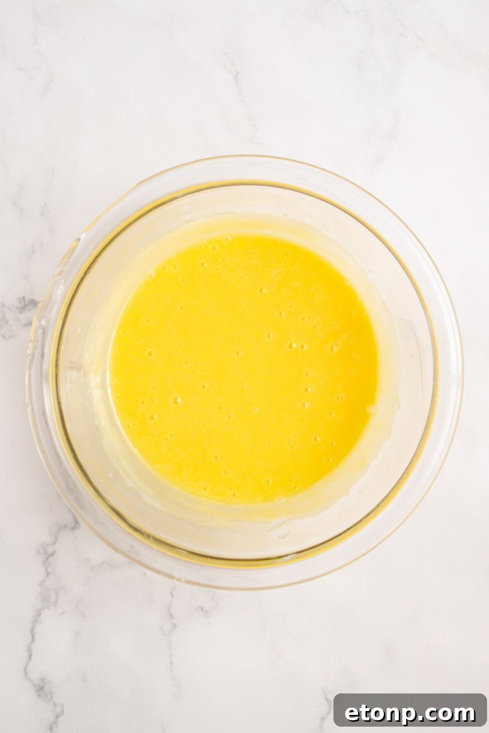 egg mixture in a glass bowl for Coconut Meringue Pie