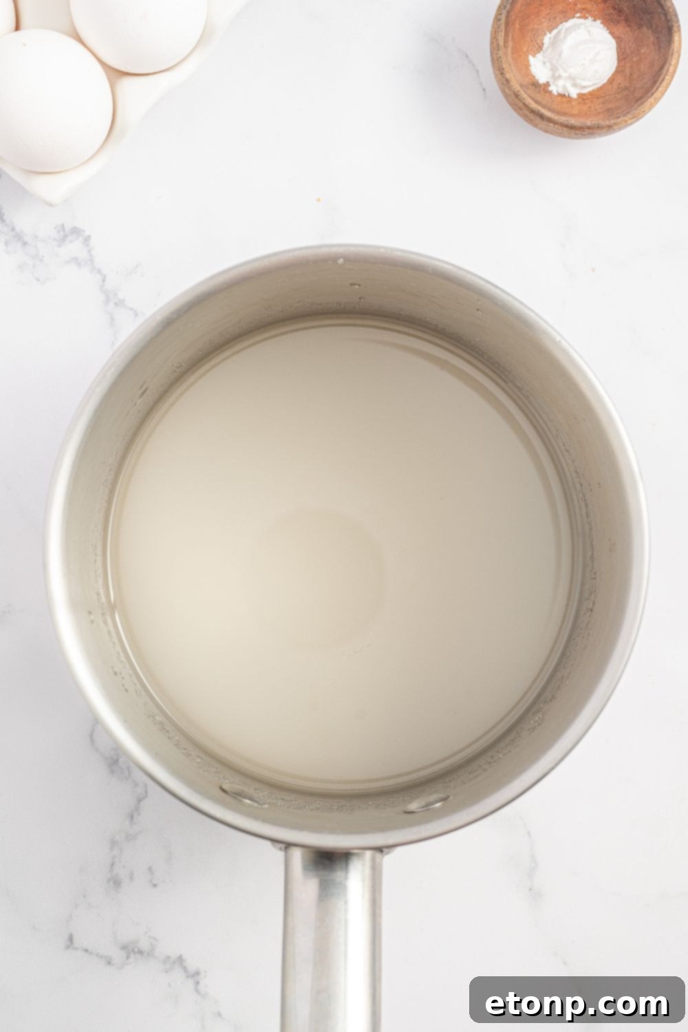 mixture for making a Coconut Meringue Pie in a saucepan