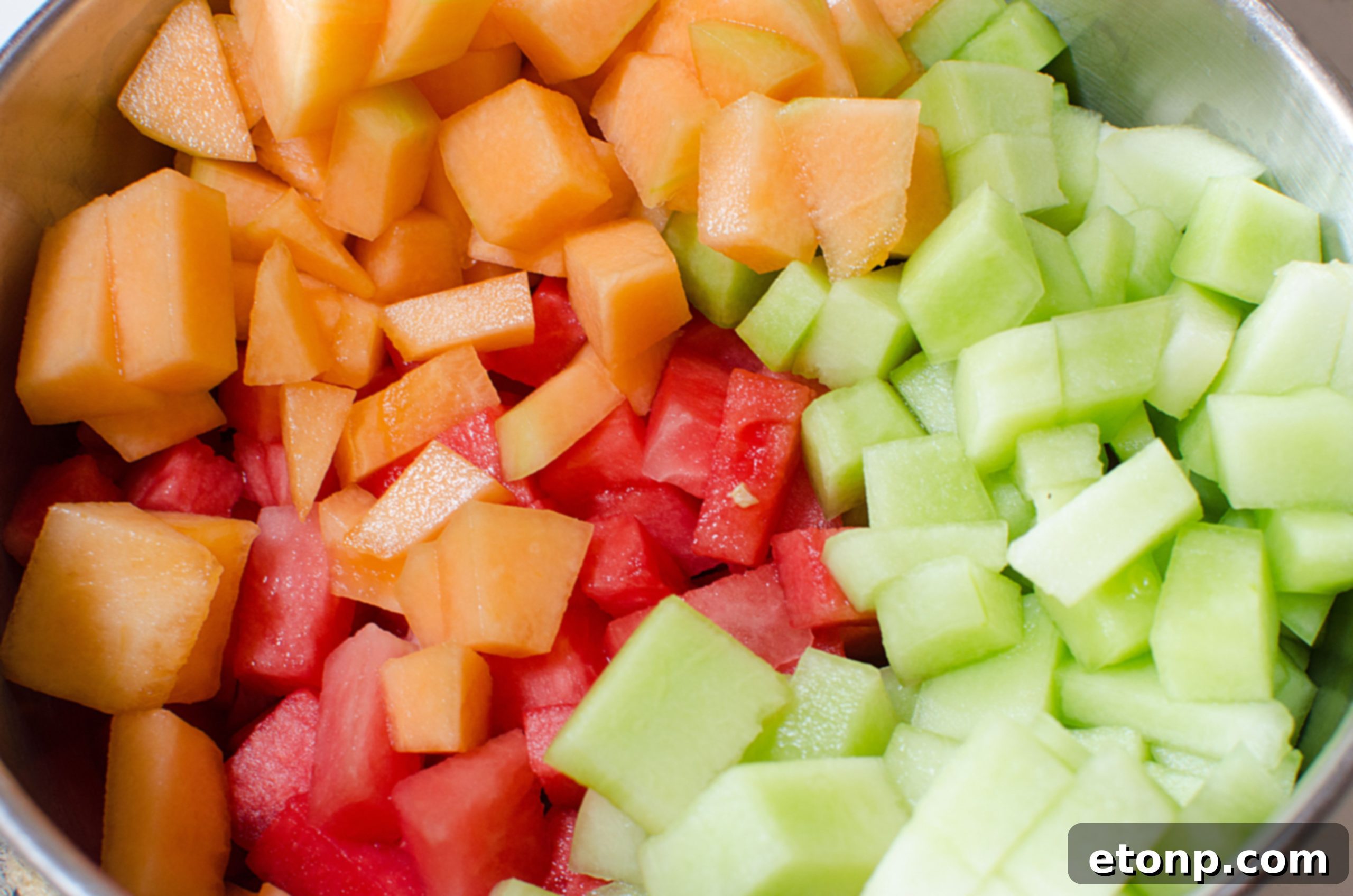Close-up of the delicious, glossy glaze coating the fresh fruit in the salad