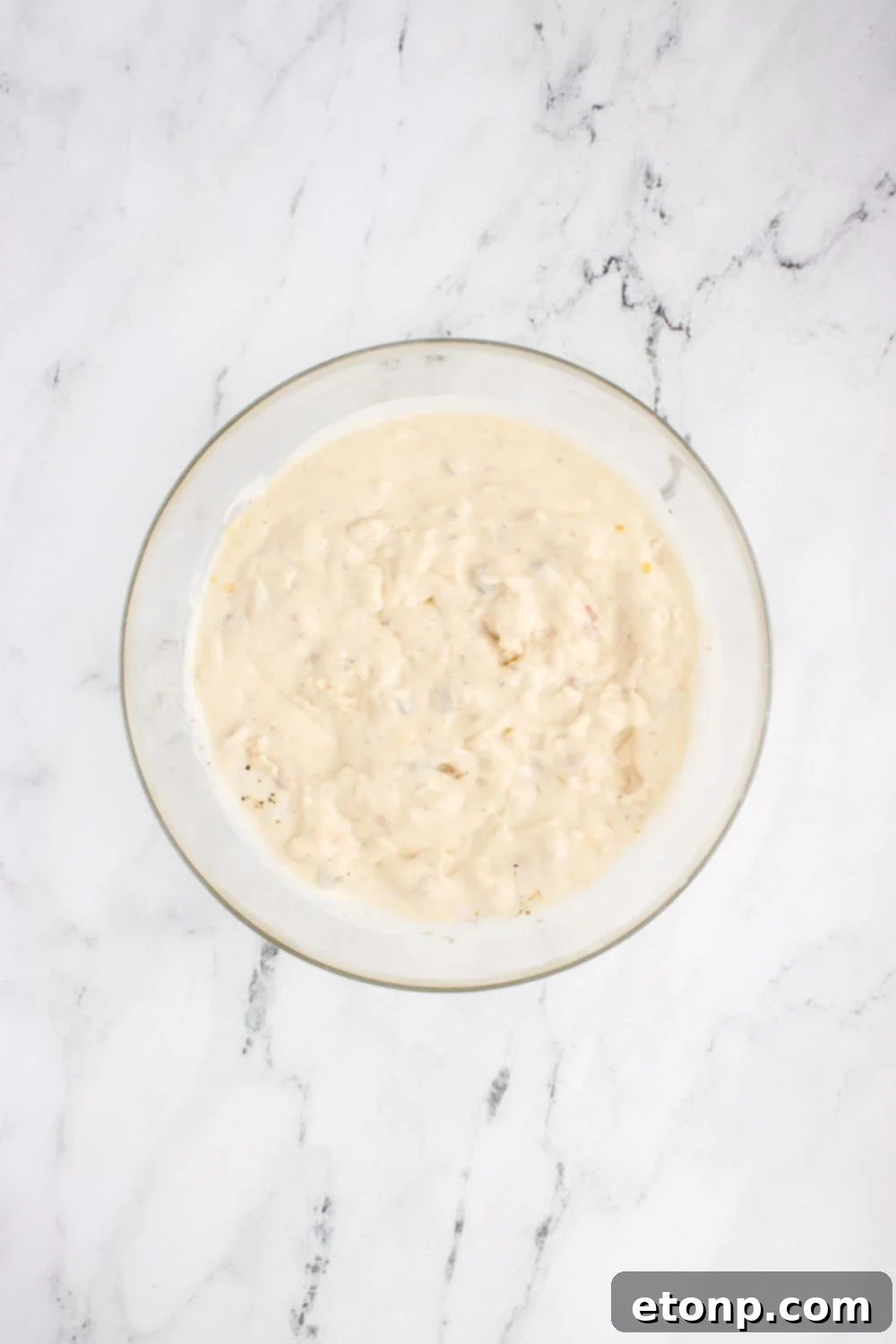 cream sauce mixed up in bowl on table for chicken tetrazzini