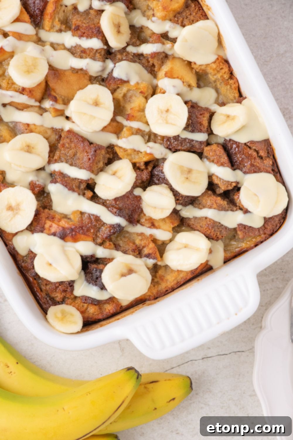 overhead look of Banana Bread Pudding in a casserole dish on table 