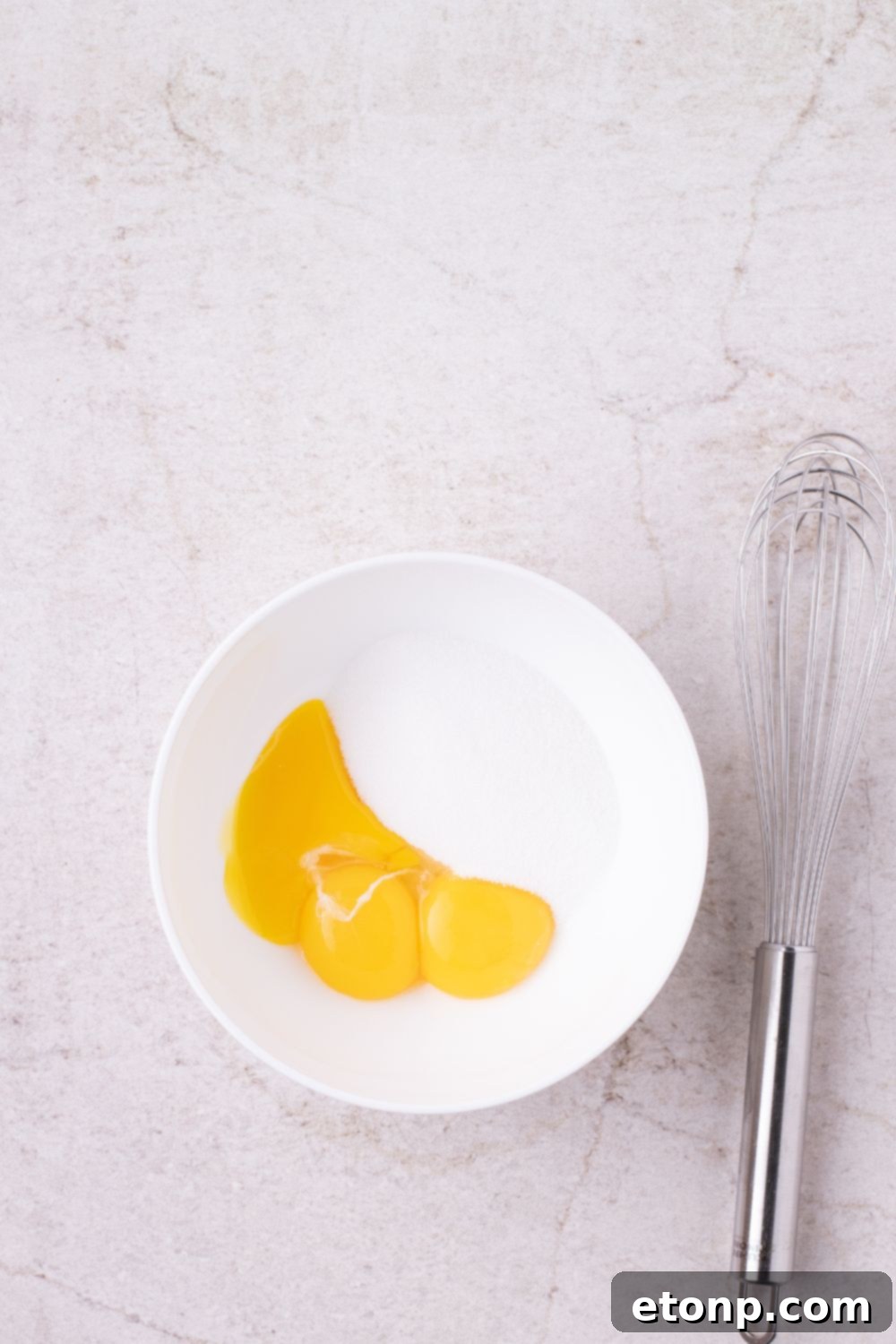 egg and milk mixture in a bowl with whisk by it