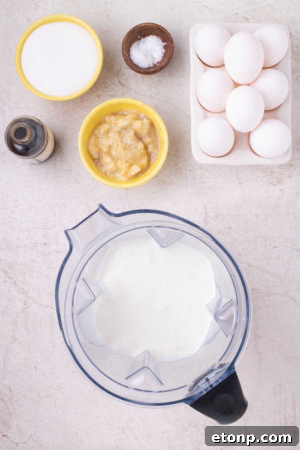 ingredients for Banana Bread Pudding in bowls and a mixer on table 