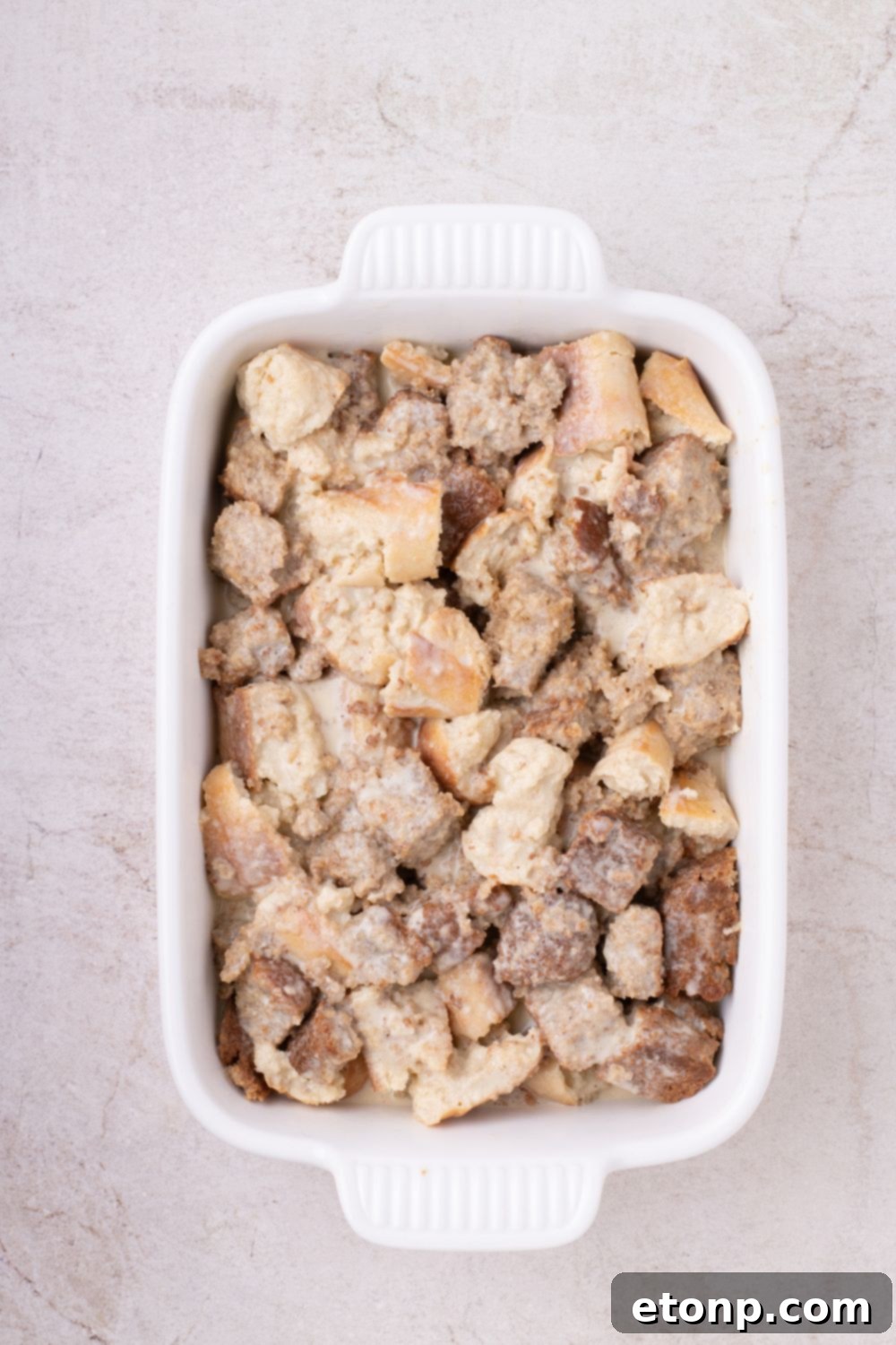 raw Banana Bread Pudding in casserole dish on table 