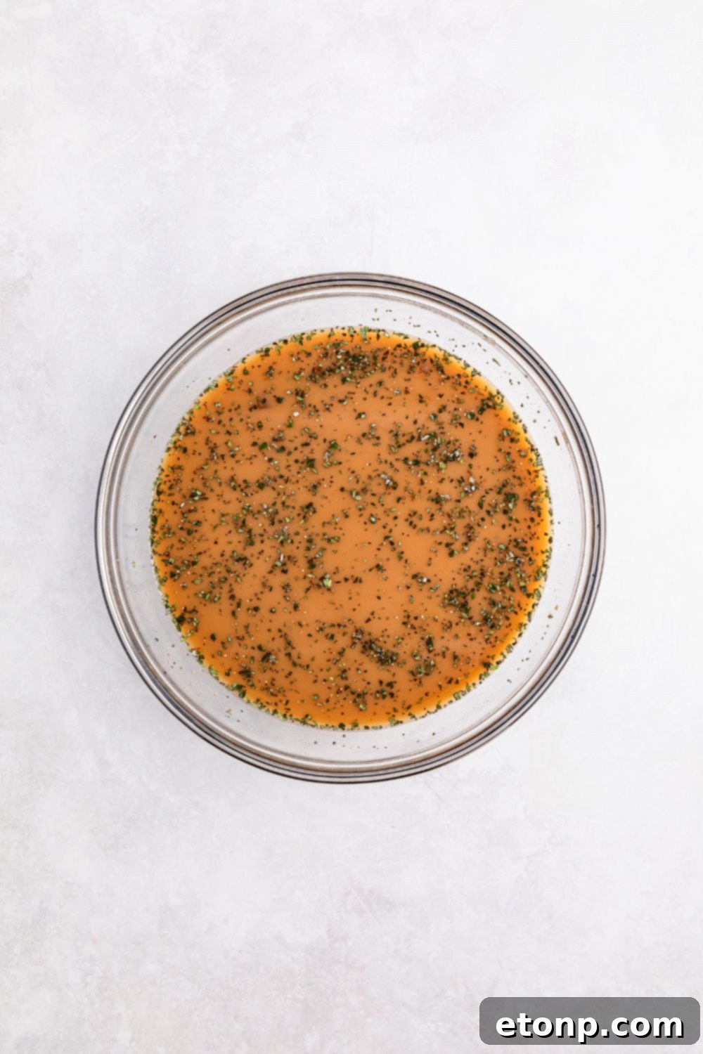 sauce in a glass bowl for making Crock Pot French Onion Meatballs