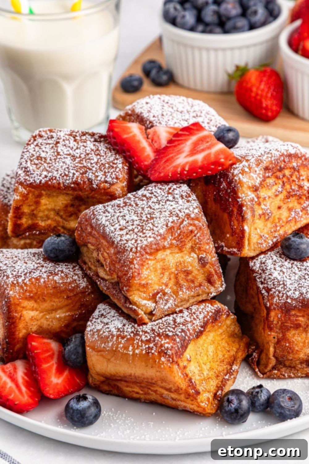 a plate showcasing Hawaiian Roll French Toast pieces beautifully arranged with fresh berries