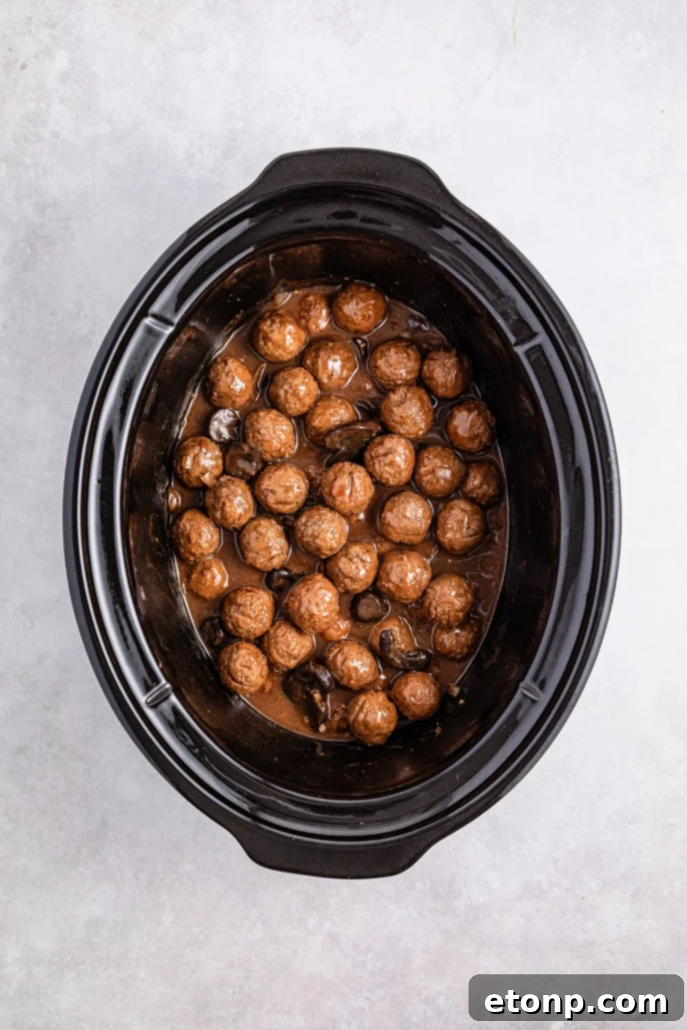 Comforting Slow Cooker Salisbury Steak Meatballs 11 Crock Pot Salisbury Steak Meatballs in a crock pot on white table