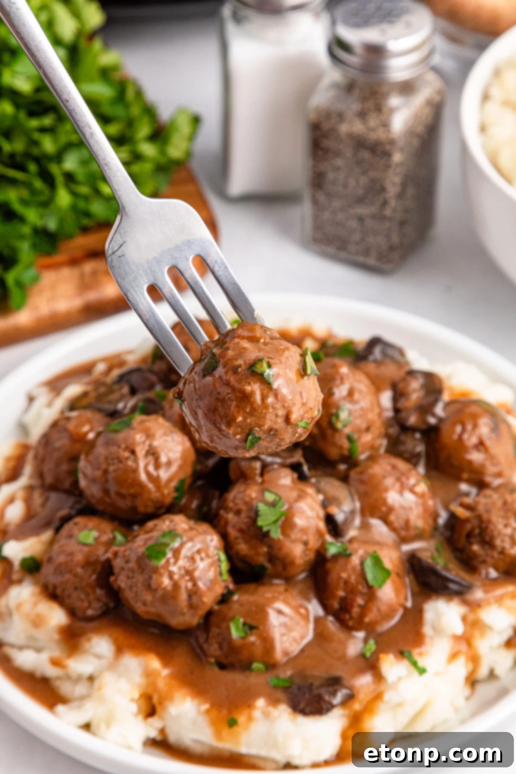 Comforting Slow Cooker Salisbury Steak Meatballs 17 Crock Pot Salisbury Steak Meatballs over mashed potatoes in a white plate