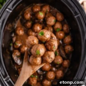 Comforting Slow Cooker Salisbury Steak Meatballs 19 Crock Pot Salisbury Steak Meatballs in crock pot with a spoon with a few meatballs in it above crock pot