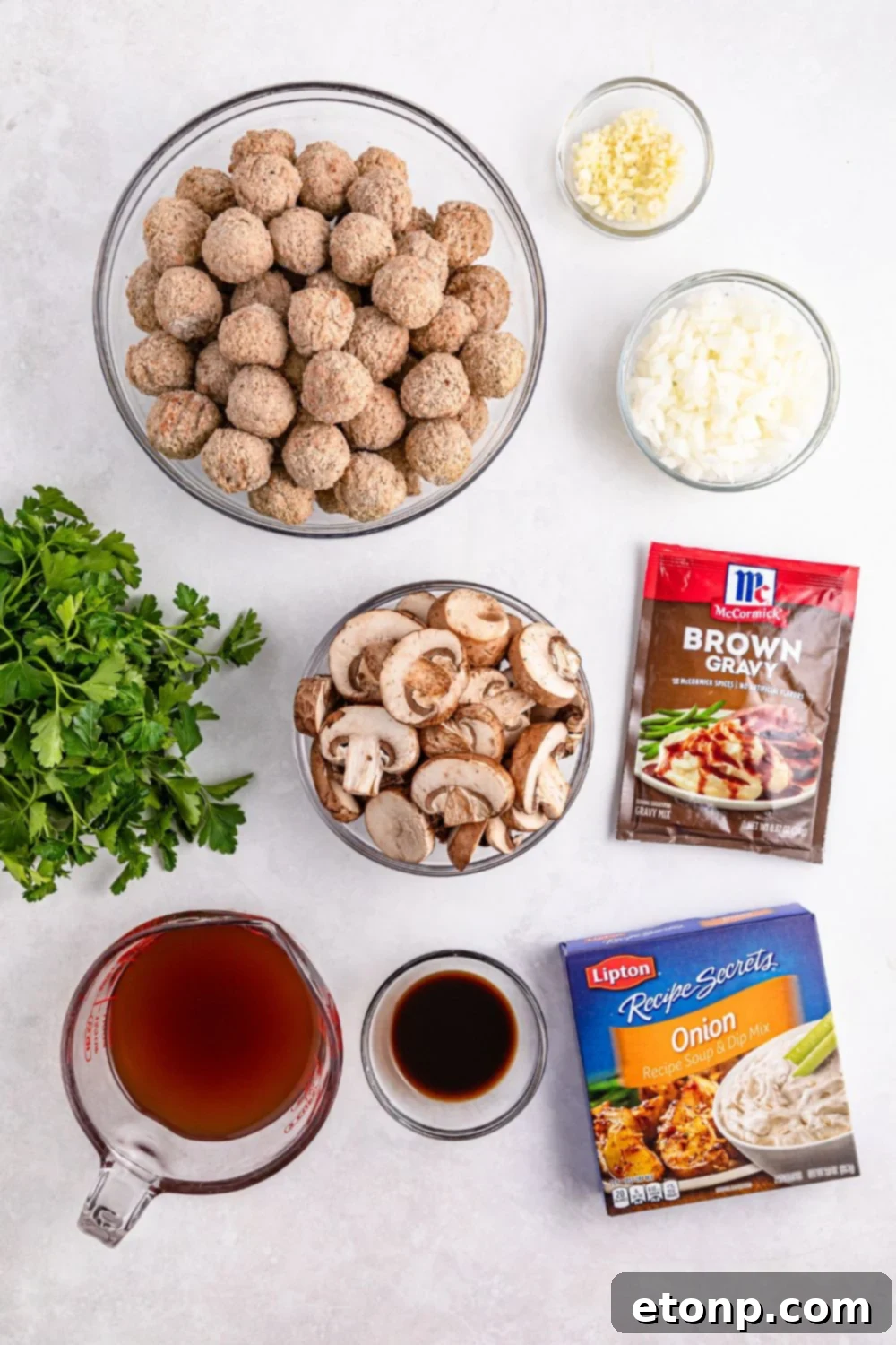 Comforting Slow Cooker Salisbury Steak Meatballs 7 Crock Pot Salisbury Steak Meatball ingredients on a white table in single serve bowls to show each ingredient