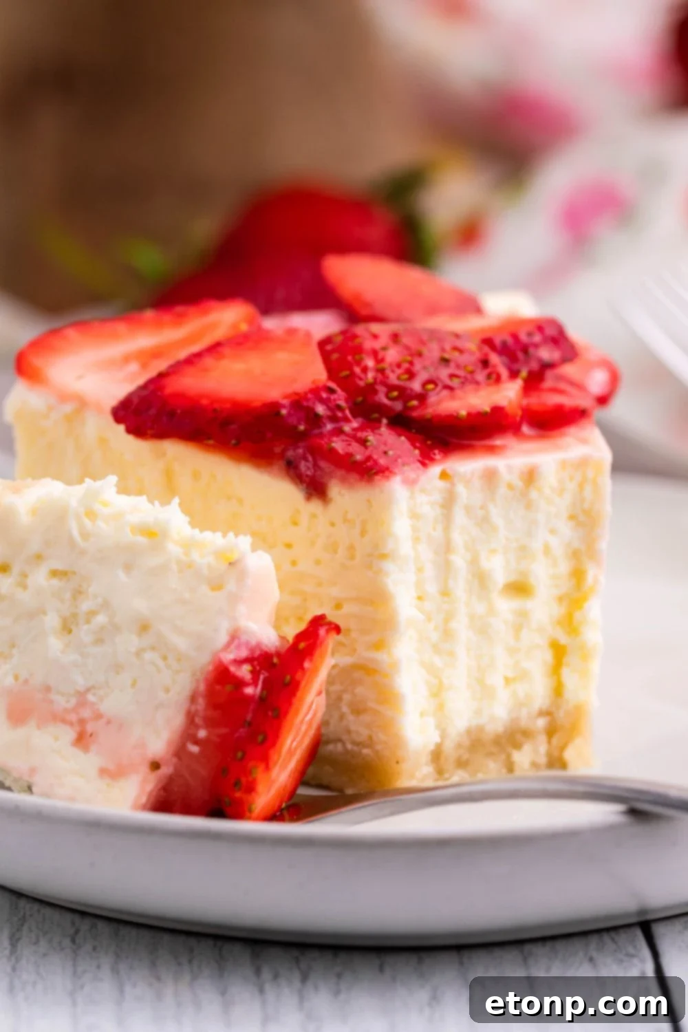 Keto Cheesecake on small plate with a bite taken out of the cheesecake slice 