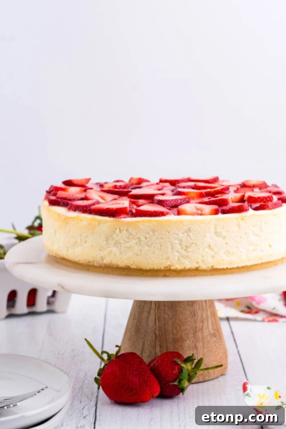 Keto Cheesecake on a cake platter on table 