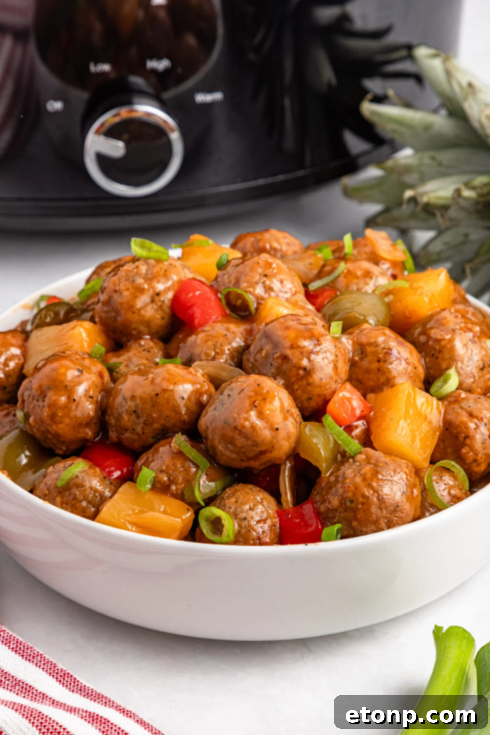 Crock Pot Sweet And Sour Meatballs in a large white serving bowl