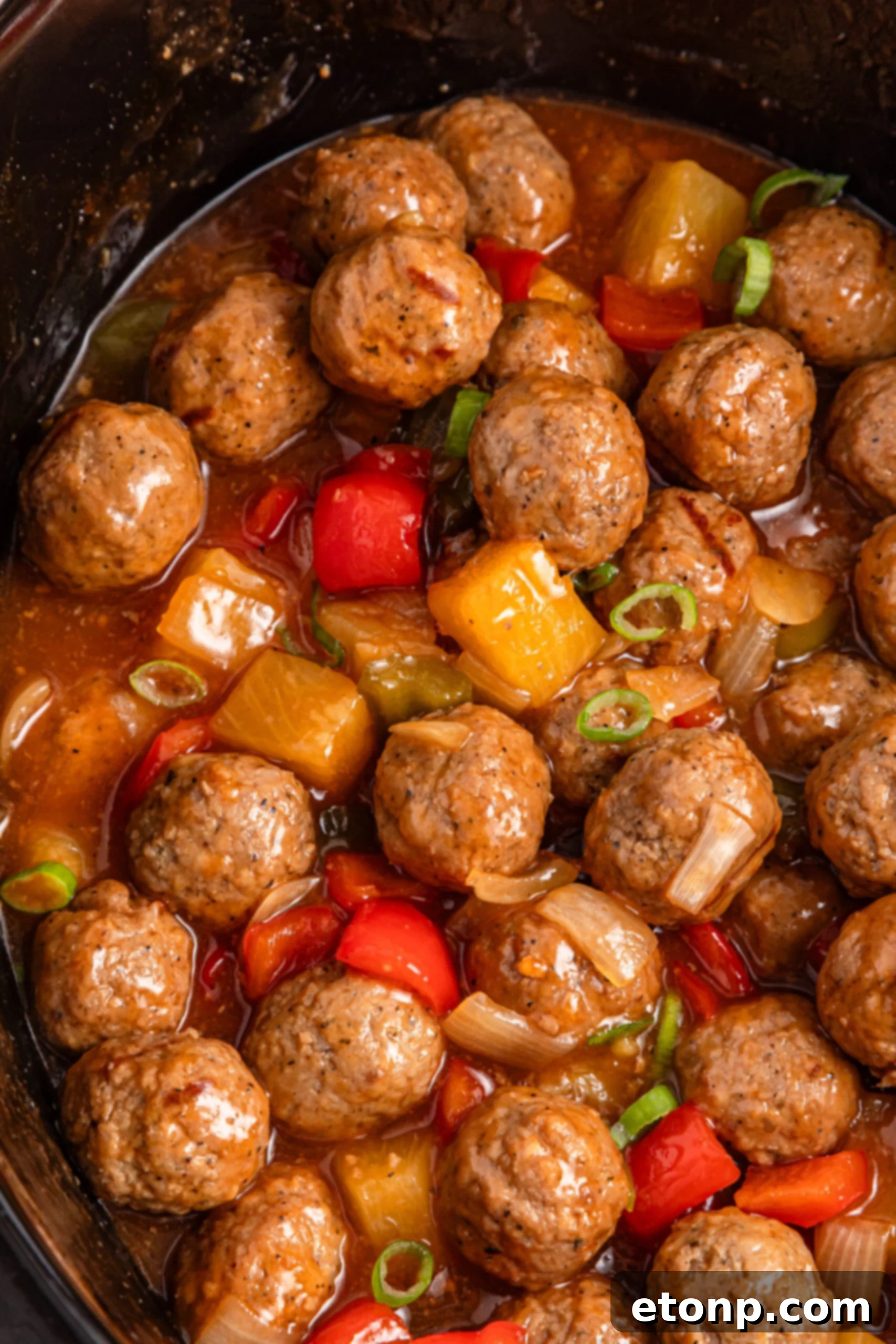 Up close shot of the crock pot sweet and sour meatballs in a crock pot 