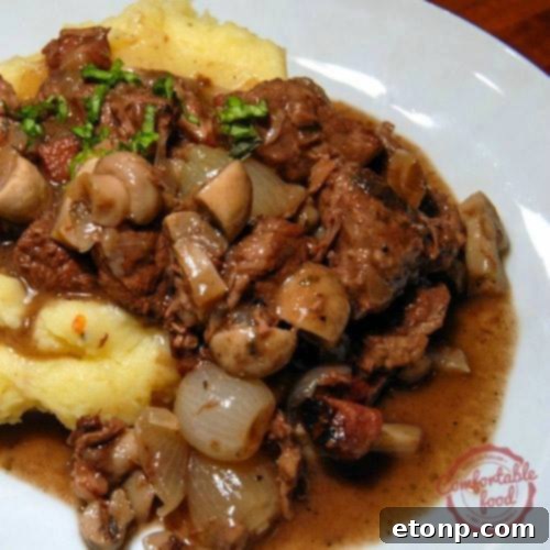 Rich and tender Beef Burgundy (Bourguignon) served with fresh herbs