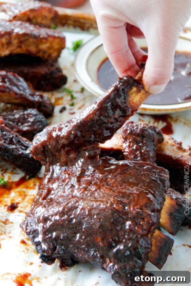 Succulent fall-off-the-bone BBQ ribs from a slow cooker, garnished with herbs