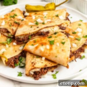 The Mississippi Pot Roast Remix 20 Mississippi Pot Roast Quesadillas stacked on a plate with cilantro and onions on top