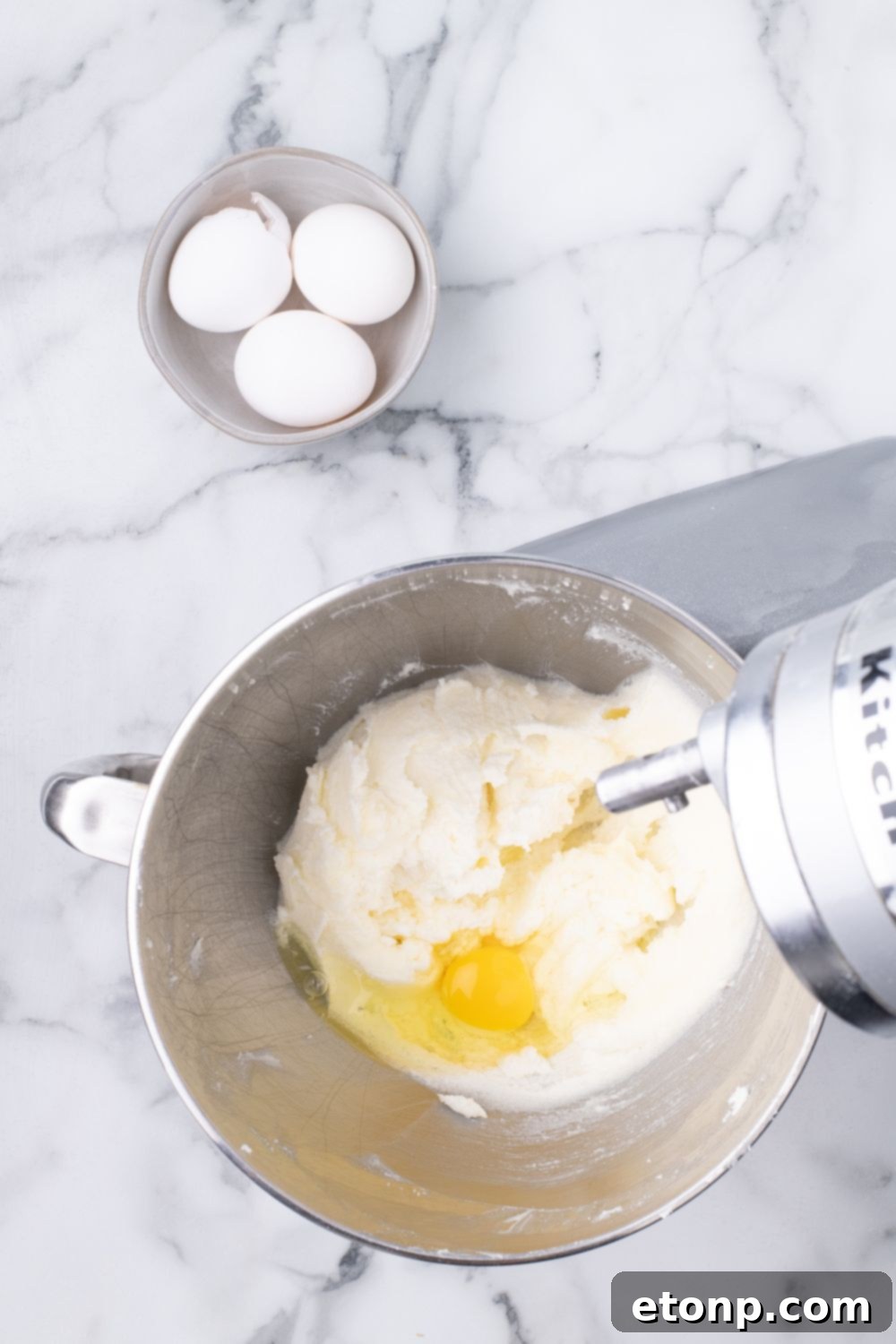 stand mixer with eggs and cake batter in it