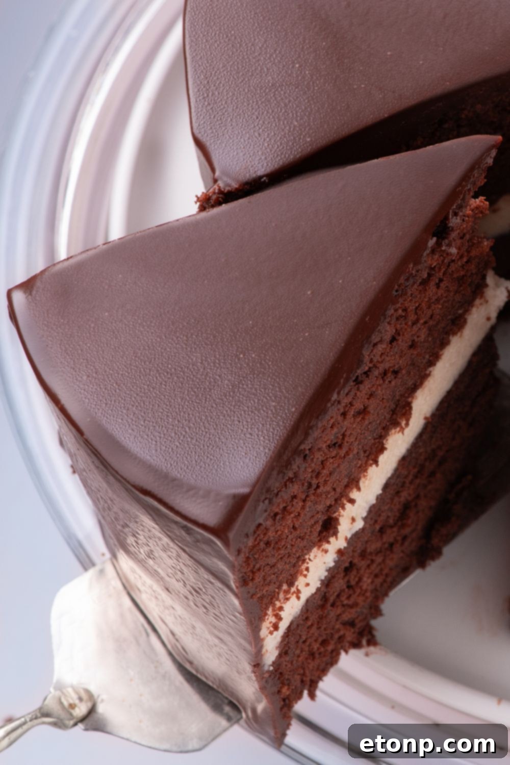 Hostess Ding Dong Cake on plate with a slice of cake being lifted out with a spatula 