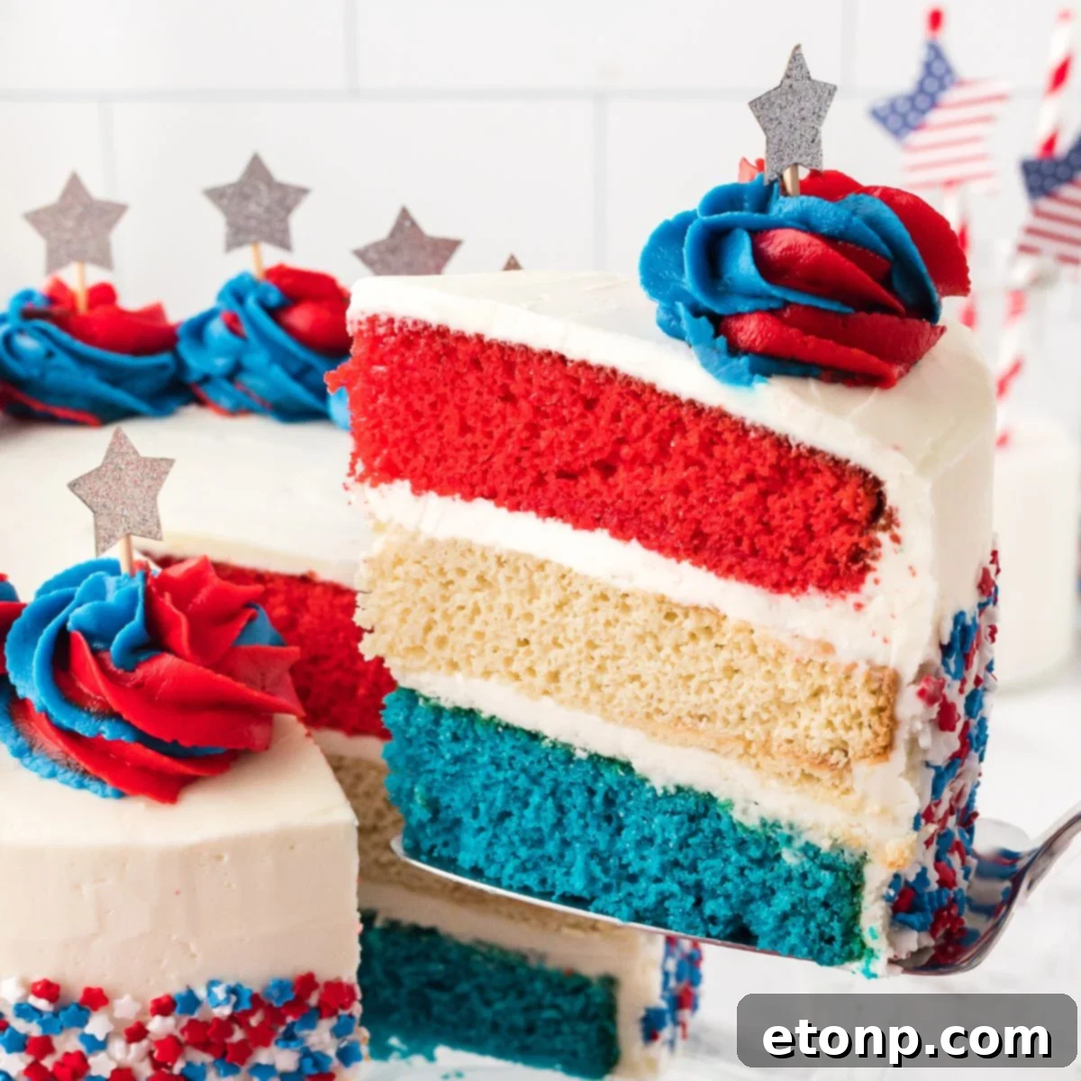 American Flag Cake with a slice being lifted out with spatula 