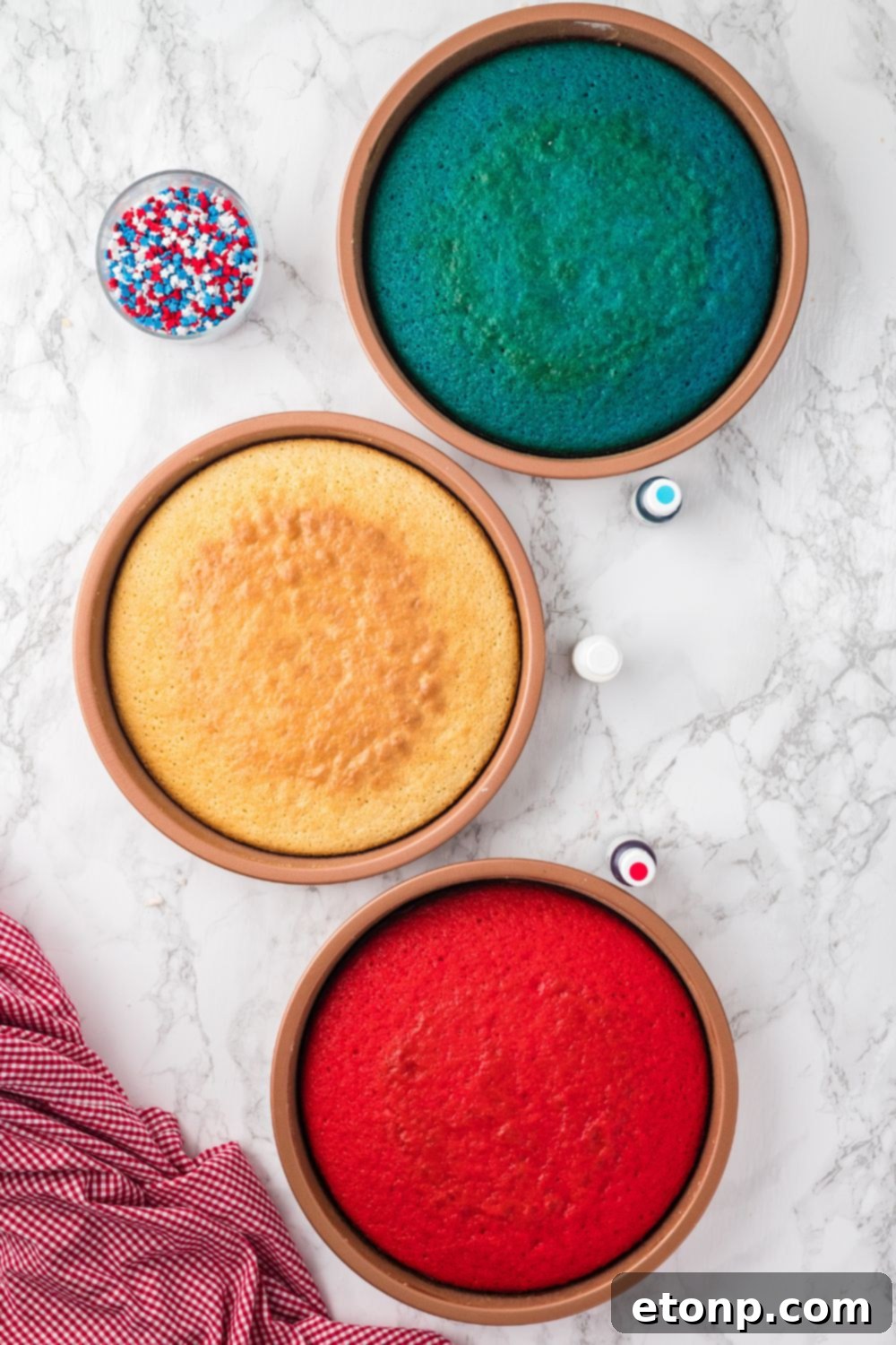 round cakes that are red, white, and blue sitting on table in pans 