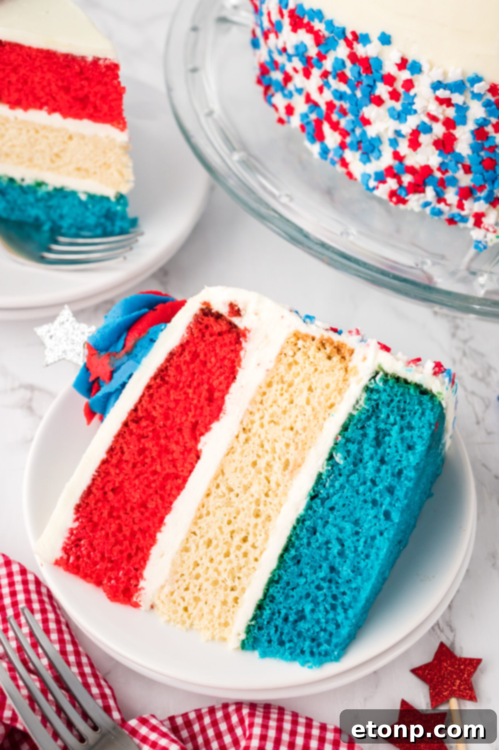 overhead shot of a Slice of American Flag Layered Cake on a white plate 