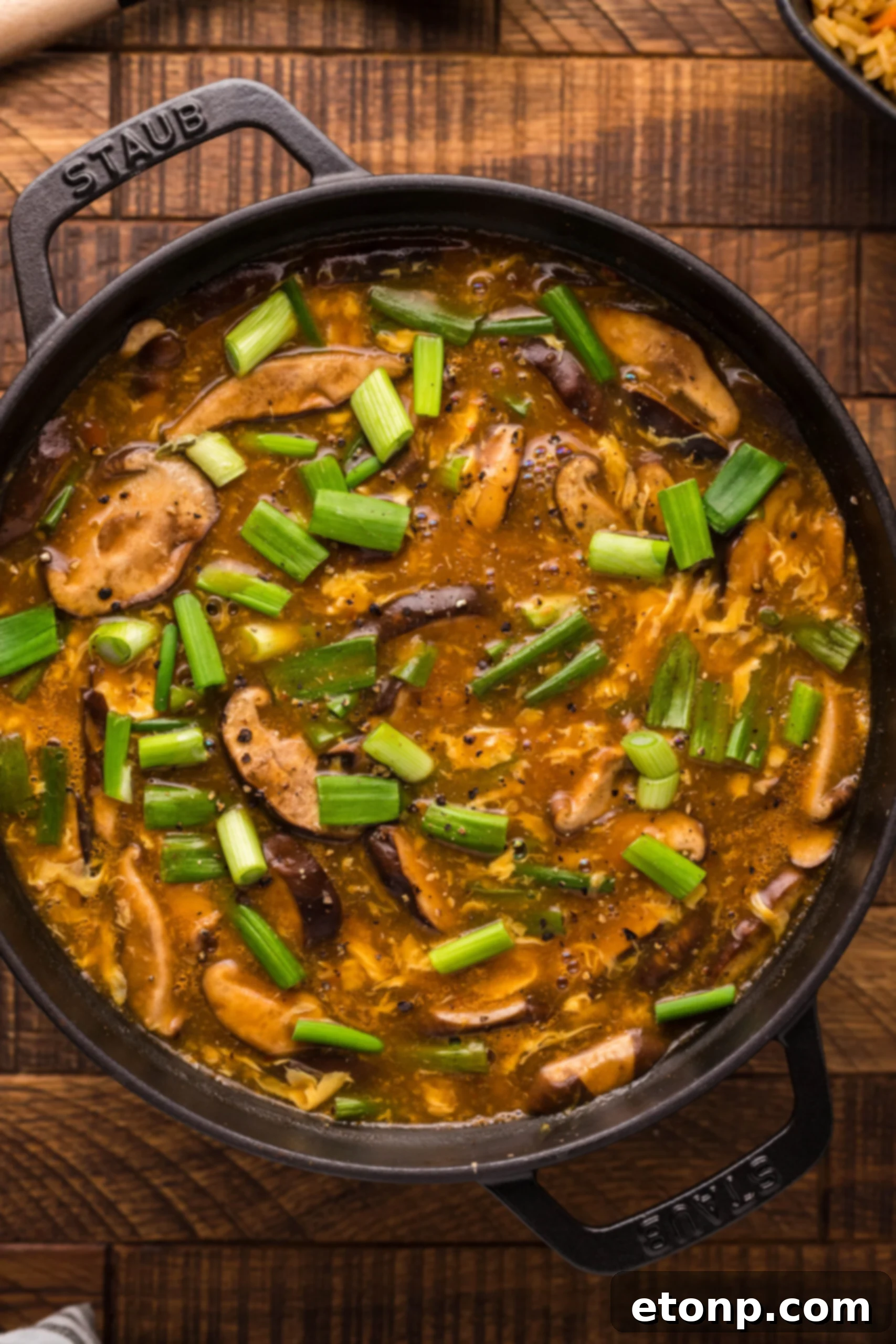 A large pot brimming with P.F. Chang's style Hot and Sour Soup, ready to be served
