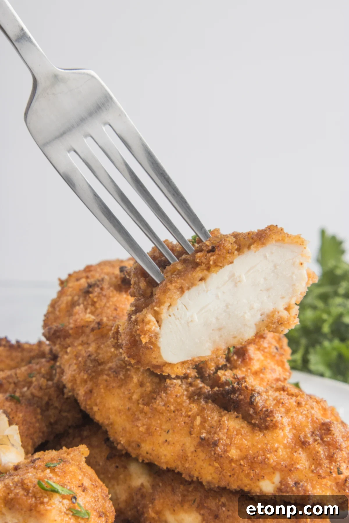 Fork lifting up a bite of the Air Fryer Chicken Tender
