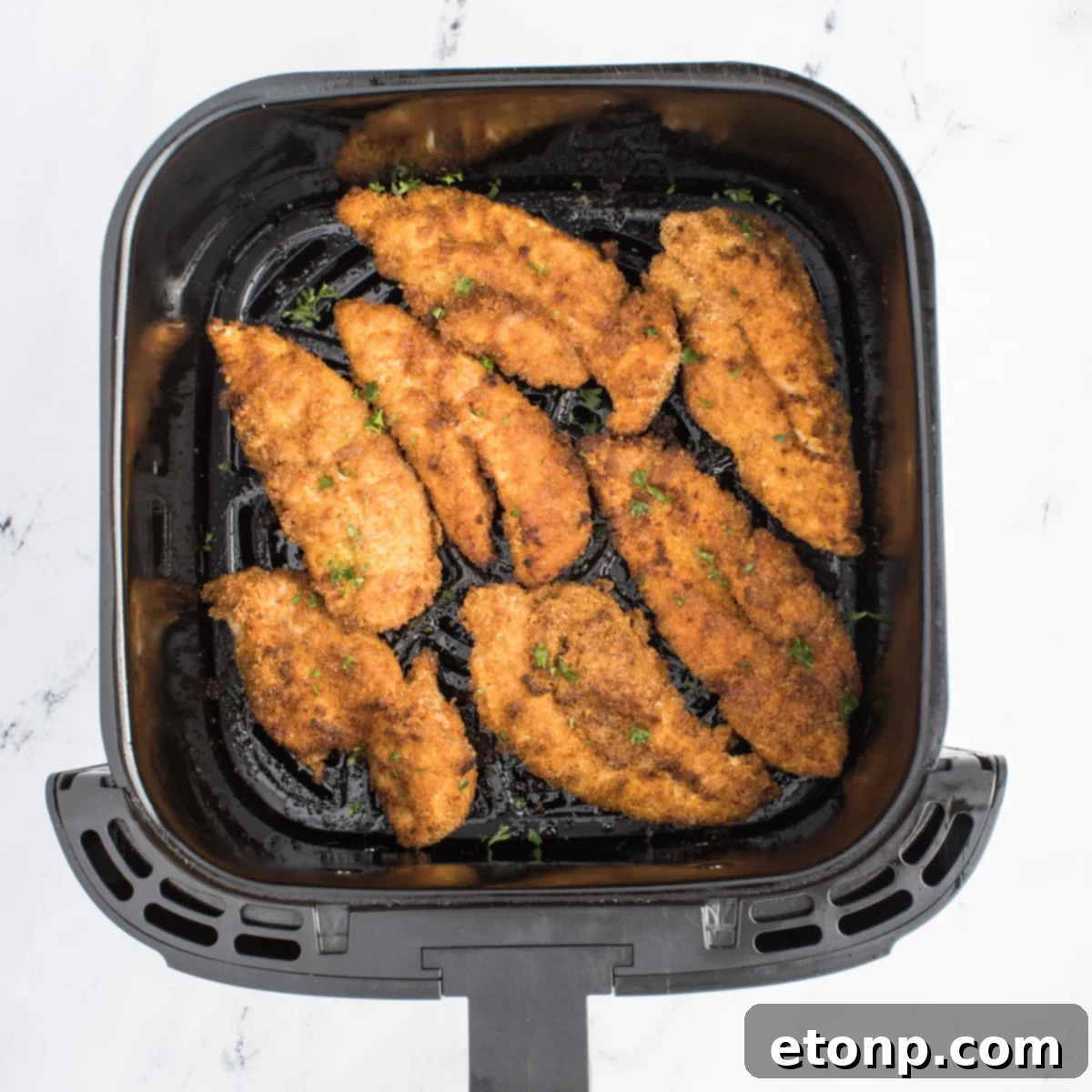 Air Fryer Chicken Tenders cooked inside the air fryer basket