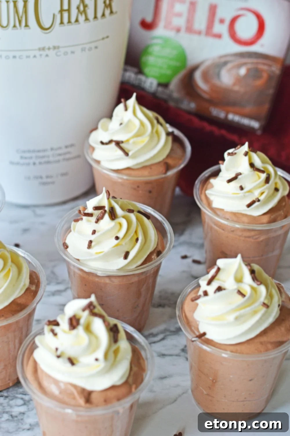 Decadent Chocolate RumChata Pudding Shots 11 Rumchata Pudding Shots on table with shots spread out over the table