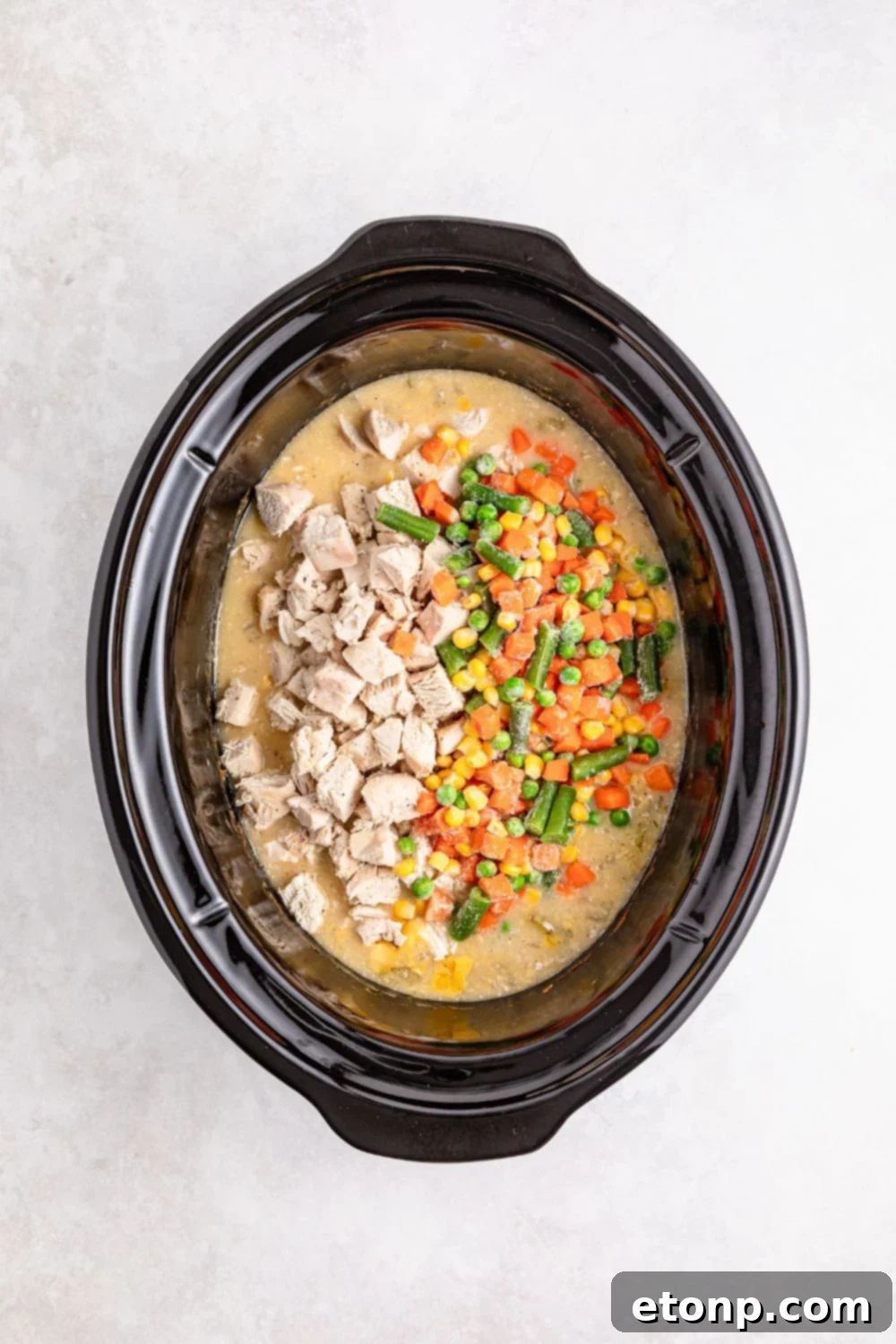 cooked Slow Cooker Chicken Pot Pie in slow cooker on table 