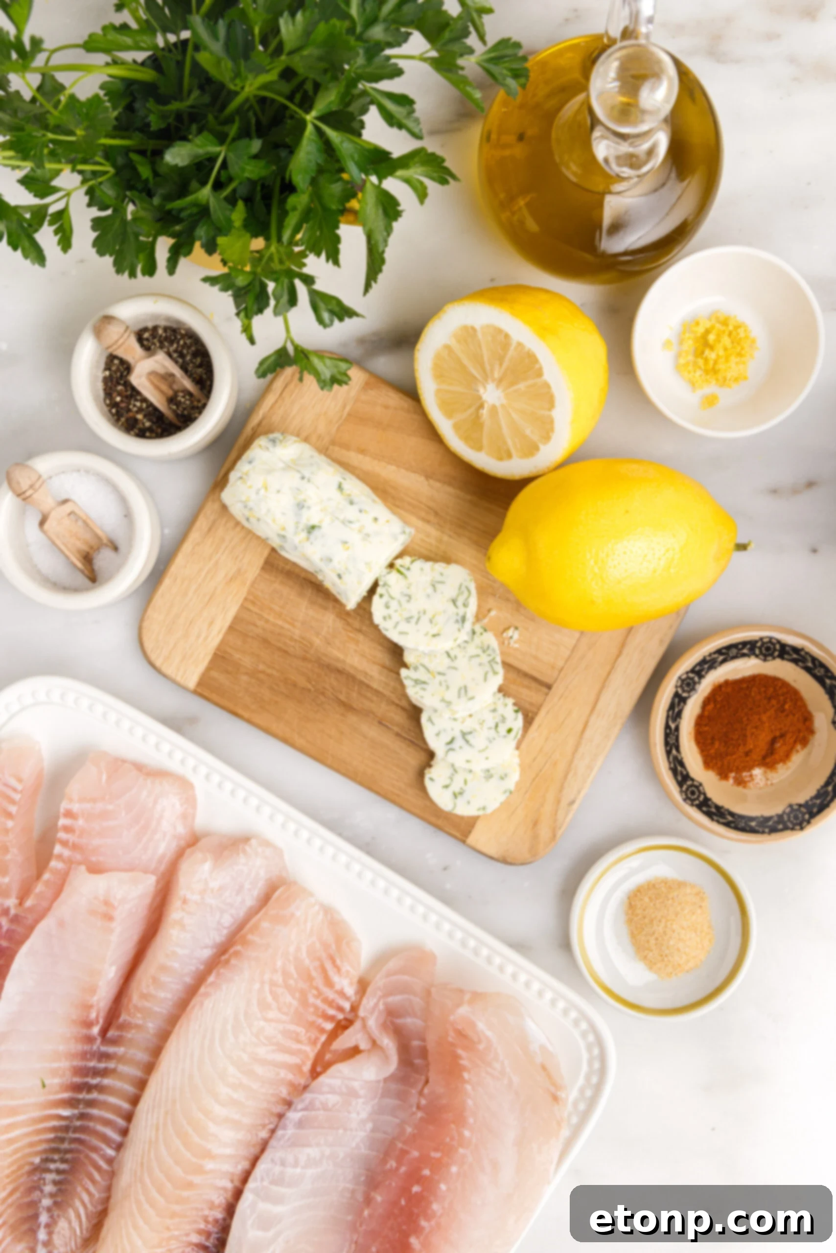 Pan fried tilapia ingredients on a white marble table laid out